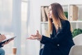 Cropped image of businesswoman in suit giving interview to journalist and gesturing Royalty Free Stock Photo