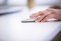 Cropped image of businesswoman using mouse at office Royalty Free Stock Photo