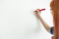 Cropped image of businesswomen writing on whiteboard in creative office Royalty Free Stock Photo