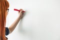 Cropped image of businesswomen writing on whiteboard in creative office Royalty Free Stock Photo