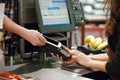 Cropped image of cashier woman create payment with phone app. Royalty Free Stock Photo