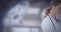 Cropped image of caucasian female doctor against surgical light in background