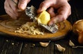 Cropped image of a cook hands grating raw potatoes with a grater to prepare chips. Culinary healthy vegetable diet concept Royalty Free Stock Photo