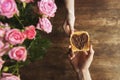 cropped image of couple holding toast with chocolate paste in shape of heart, valentines