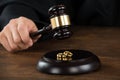 Divorce Judge Hitting Gavel On Golden Rings At Desk