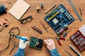 cropped image of electronic engineer with robotic hand soldering hard rive