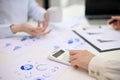 Cropped image of a female accountant using calculator, calculating and analyzing financial data Royalty Free Stock Photo