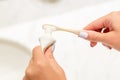 Cropped image of female hands putting toothpaste on the toothbrush in the bathroom. Dental care concept. Preparation for teeth Royalty Free Stock Photo