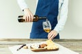 Cropped image of Female sommelier pouring white wine