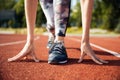 Cropped image of a female sprinter getting ready to run