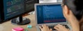Female developer coding on laptop while computer display program. Burgeoning. Royalty Free Stock Photo