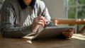 Cropped image of a female working on her tasks on her tablet at the cozy coffee shop Royalty Free Stock Photo