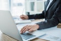 cropped image of financier using laptop at table