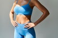 Cropped image of fit woman torso on grey background Royalty Free Stock Photo