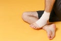 Cropped image of fitness sporty guy sportsman in black shorts spend weekend in home gym isolated on yellow background