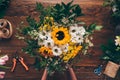 cropped image of florist putting bouquet of flowers