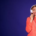 Cropped image of funny blond biting cord of headphones