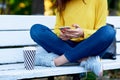 Cropped image of a girl holds in hands the smartphone during buying on sales. Young woman using mobile phone during conversation