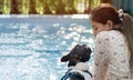 Cropped image of Girl kissing her dog pet cute adorable French bulldog friendly at the swimming pool. Royalty Free Stock Photo