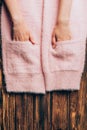 cropped image girl putting hands in pockets of pink sweater