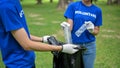 Cropped image of a group of volunteers collecting trash, cleaning an area in the public park