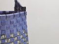 Cropped image of handmade bag from plastic strap isolated on grey background.