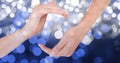 Cropped image of hands against glowing bokeh Royalty Free Stock Photo