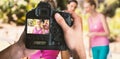 Composite image of cropped image of hands holding camera Royalty Free Stock Photo