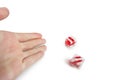 Cropped image of hands throwing gambling dice over white background