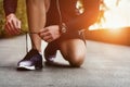 Close-up of sportsman tying sneakers. Unrecognizable man stopping lacing shoe outdoors. Athletic shoes concept. Royalty Free Stock Photo