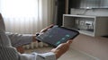 Cropped image hands are using a tablet with home devices controlled applications on the screen Royalty Free Stock Photo