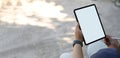 A cropped image of hands is using a white blank screen computer tablet and stylus pen. Royalty Free Stock Photo