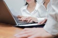 Cropped image of hands of young Asian business people working together on a laptop computer at office. Teamwork brainstroming conc Royalty Free Stock Photo