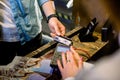 Cropped image of the hands of young man paying for hotel room at reception, using a credit card Royalty Free Stock Photo