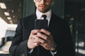 Handsome business man near business center using mobile phone. Royalty Free Stock Photo