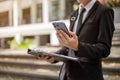 Cropped image of a businessman is checking messages on his phone while walking down the stairs Royalty Free Stock Photo