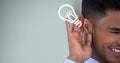 Cropped image of happy businessman listening idea against green background Royalty Free Stock Photo