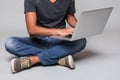 Cropped image of a happy smiling casual man sitting on the floor with laptop Royalty Free Stock Photo