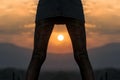 Cropped image legs of young woman silhouette at sunset