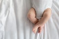 Cropped Image Of Little Baby In Diaper And Bodysuit Lying On Bed Royalty Free Stock Photo