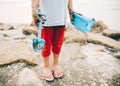 Cropped image little girl with muddy hand holding tool toy