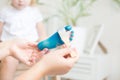 Cropped image of little girl sitting on the bed at home while mom is painting her feet using water colors and gouache Royalty Free Stock Photo