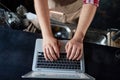 cropped image of a male bartender using a laptop.