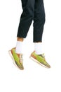 Cropped image of male body, legs in blue jeans and colorful sneakers isolated over white studio background. Hanging Royalty Free Stock Photo