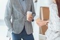 cropped image of male and female colleagues having coffee break