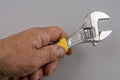 Cropped image of male hand holding adjustable wrench Royalty Free Stock Photo