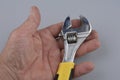 Cropped image of male hand holding adjustable wrench Royalty Free Stock Photo
