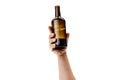 Cropped image of male hand holding bottle of strong alcohol drink isolated over white background