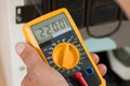 Repairman Checking Fridge With Digital Multimeter Royalty Free Stock Photo