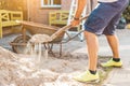 Cropped image of man digging sand with a shovel Royalty Free Stock Photo